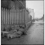 Soldats de la 1re DB (division blindée), guettant en position de tir, armés d'une mitrailleuse Browning 7,62 mm, dans Mulhouse lors des combats livrés contre les troupes allemandes pour la reconquête de la ville.