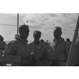 Pierre Messmer, ministre des Armées, Alain Peyrefitte, ministre de la Recherche scientifique et des Questions atomiques et spatiales, et le général de corps aérien Jean Thiry, directeur des centres d'expérimentations nucléaires (DIRCEN), en tenue de protection à bord du croiseur de commandement De Grasse lors du déclenchement de l'essai nucléaire Bételgeuse sur l'atoll de Moruroa.