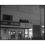 Fernand Grenier, commissaire à l'Air, et les autorités militaires pendant l'éxécution de la Marseillaise dans un hangar de l'atelier industriel de l'Air (AIA) de Maison Blanche.
