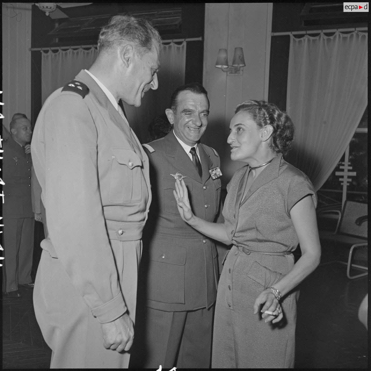 General Gilles, commander of the airborne troops (TAP) in the Far East (center), speaks with guests at the reception organized for his departure.