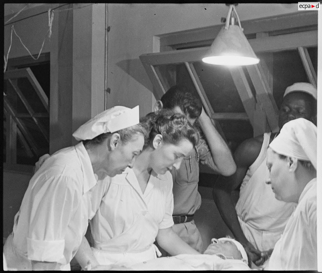 A legionnaire from the 13 DBLE (half-brigade of the Foreign Legion), wounded in the battle of Dien Bien Phu, waits in the triage room of the Lanessan military hospital.