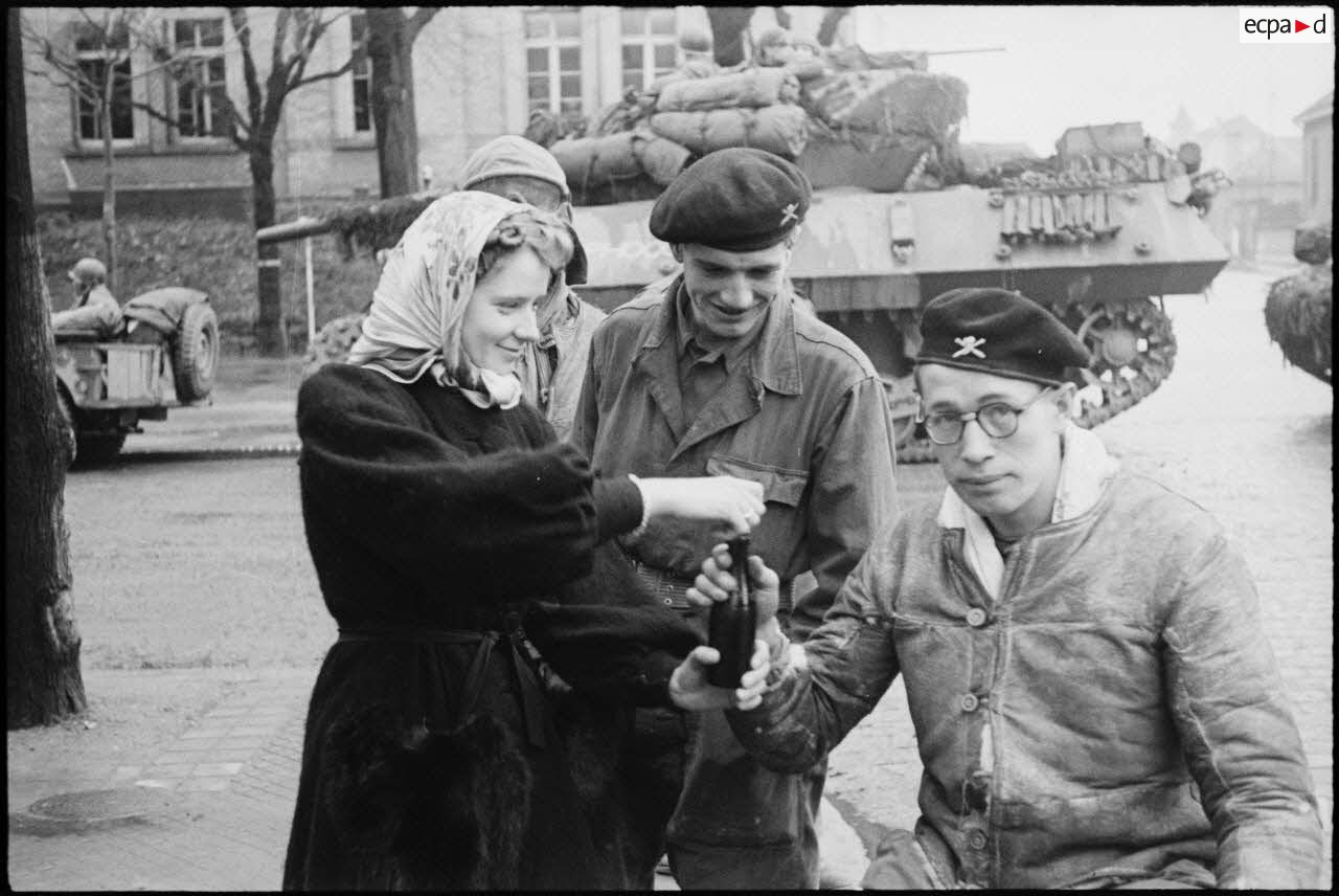 Une jeune Strasbourgeoise offre à boire à un tankiste du 501e RCC (régiment de chars de combat) dans la ville libérée.