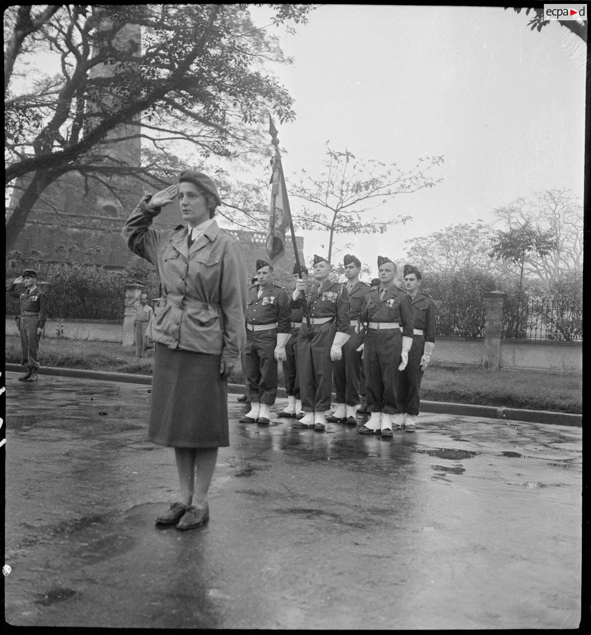 Geneviève Grall, nurse of the GLAP (Light Airborne Group), stands at attention during a parade in Hanoi.