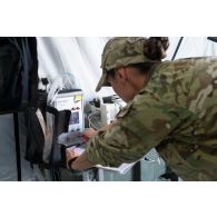 Un élément du personnel de santé du 250e FST (forward surgical team ou équipe chirurgicale de campagne) règle un ventilateur portable dans le cadre d'un exercice MASCAL (mass casualties ou afflux de blessés) entrepris conjointement avec les forces françaises et américaines présentes sur le camp militaire de la ville irakienne d'Al-Qaïm, située à proximité de la frontière avec la Syrie.