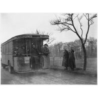 Un autocar Renault TN4B est photographié de trois quarts dos sur une route de Lorraine.