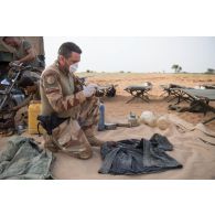 Le maréchal des logis-chef Laurent de la gendarmerie prévôtale prend en photographie des matériels saisis aux groupes armés terroristes (GAT) dans le secteur de N'Daki, au Mali.