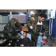 Activités de l'hôpital jordanien de Mazar e Charif. Un enfant en consultation sur le siège du dentiste.