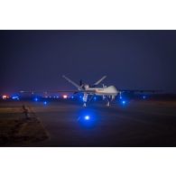 Un drone General Atomics MQ-9 Reaper stationne au parking à la tombée de la nuit à Niamey, au Niger.