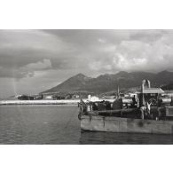 A Samos, dans le port de Karlovassi (nord-ouest de l'île), au premier plan un navire de débarquement rapide de la Kriegsmarine, Marinefährprahm ou MFP (F370), derrière des hydravions Junkers Ju-52.