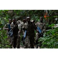 Des soldats congolais évacuent leur camarade blessé pour un exercice en forêt à Libreville, au Gabon.