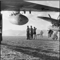 Des mécaniciens du groupe de chasse 1/22 Saintonge observent quelques-uns des neuf Bearcat décoller pour une mission de bombardement sur la route provinciale 41.