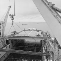 Deux barges transportant des shelters se présentent à l'entrée du radier du transport de chalands de débarquement (TCD) Ouragan dans le lagon de l'atoll de Moruroa.