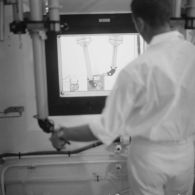 Le centre de manipulation d'éléments radioactifs du service mixte de sécurité radiologique (SMSR) à Hao. Protégé derrière une vitre, un technicien manipule des échantillons avec des pinces téléguidées.