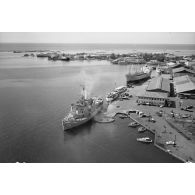 Vue aérienne du brise-glace américain USS Staten Island (AGB-5) à quai dans le port de Papeete, octobre 1964 ou mars 1965.