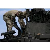 Des soldats belges alimentent un véhicule blindé Piranha IIIC DF30 en obus de 30 mm sur le champ de tir de Cincu, en Roumanie.