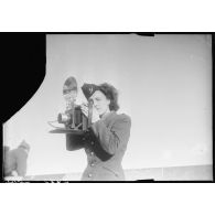 Une photographe des forces féminines de l'Air équipée d'un appareil Speed Graphic.