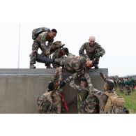 Des légionnaires de la 13e demi-brigade de la légion étrangère (DBLE) font franchir un obstacle à leur camarade sur un parcours du combattant à Tapa, en Estonie.