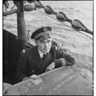 Portrait du lieutenant de vaisseau Pierre Sonneville, commandant le sous-marin des Forces navales françaises libres (FNFL) la Minerve, dans la baignoire du kiosque du bâtiment au cours d'un exercice.