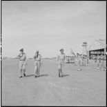 Le général Salan, l'amiral Auboyneau et l'amiral Radford passent les troupes en revue à l'aéroport de Gia Lam.