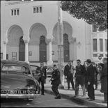 Lors de sa visite à Alger Robert Lacoste, ministre de l'Algérie, monte dans le véhicule officiel (Delahaye) stationné devant le bâtiment de la Poste.