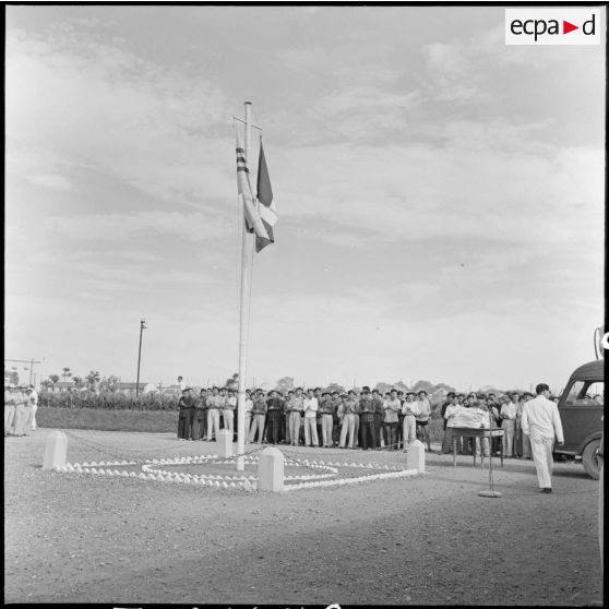 Rassemblement de PIM (prisonniers et internés militaires) dans la cour principale en face des couleurs françaises et vietnamiennes au cours d'une cérémonie pour la libération d'un groupe de prisonniers au camp de Haiduong.