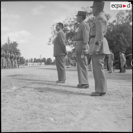 Des unités militaires défilent sous le regard du ministre des Armées, Edmond Michelet et de deux autorités militaires.