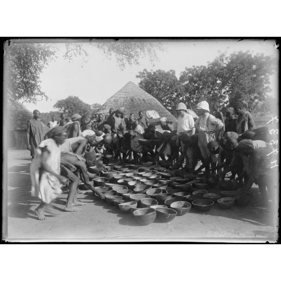 Piste de Garoua à Tschamba. Kalgé. Distribution de vivres aux porteurs. [légende d'origine]