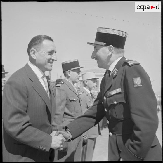 Le colonel le Demetz serre la main d'un récipiendaire. [légende d'origine]