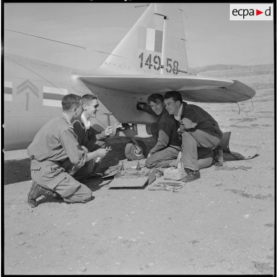[Aérodrome de Nazereg-Flinois. A droite, un pilote d'escadrille d'aviation légère d'appui (EALA) charge des munitions sur un avion North American T-6.]