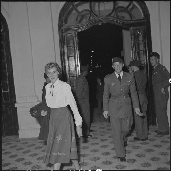 Une femme et un officier supérieur à l'entrée du  théâtre municipal d'Hanoï.