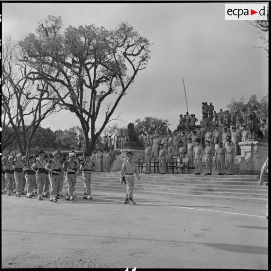 Défilé des troupes devant les ruines de l'ancien musée Maurice Long.