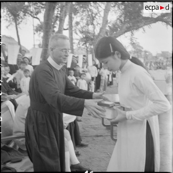 Un frère rédemptoriste remet un prix à une jeune fille.
