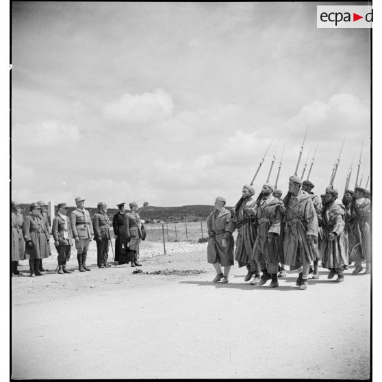 Défilé de supplétifs marocains devant les autorités lors de l'inauguration du monument érigé à la mémoire du général de division Marie-Joseph Welvert, commandant la DMC (division de marche de Constantine), décédé au cours de la campagne de Tunisie.