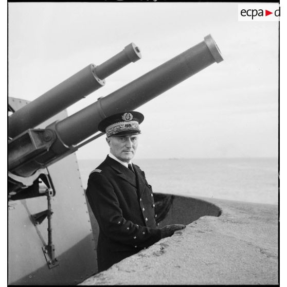 Portrait de l'amiral François Darlan, haut-commissaire de France en AFN (Afrique française du Nord), devant la tourelle d'une batterie de défense côtière dans le port d'Alger.
