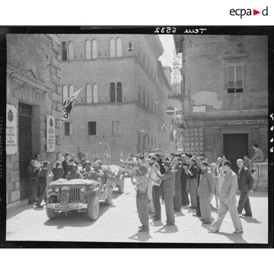Une jeep Willys, tractant un canon d'une unité des forces terrestres antiaériennes, circule dans Sienne.