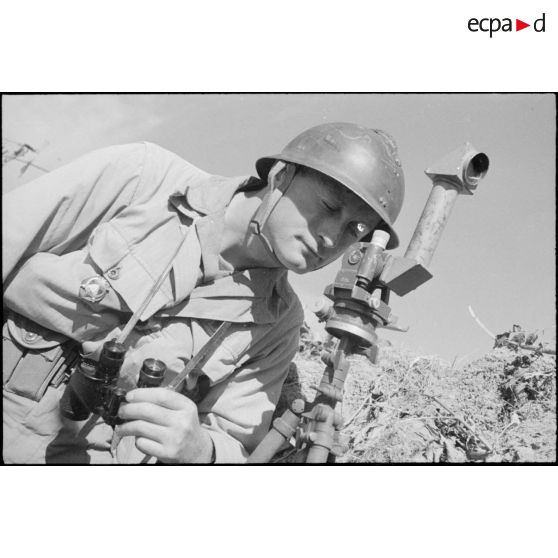 Un officier de tir de l'Armée B, équipé de jumelles et d'un binoculaire, à son poste d'observation installé à proximité du fort Lomont.