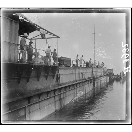 Douala. Dock flottant. Différentes phases de la mise en place d'un chaland. Manoeuvre à l'entrée du chaland. [légende d'origine]