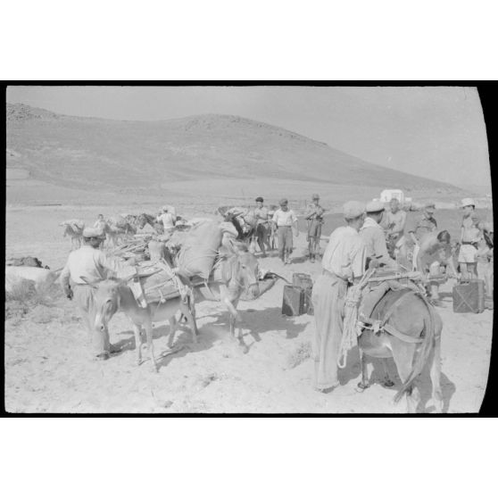Sur la côte de l'île de Naxos, des habitants sont réquisitionnés pour le transport de jerrycans.