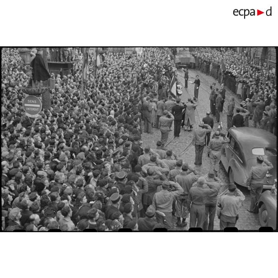 Revue des troupes par le général De Gaulle place Saint-Pierre à Besançon, devant une foule nombreuse.