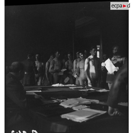 Des citoyens polonais nus passent devant des officiers français de la 1re armée pour le conseil de révision.