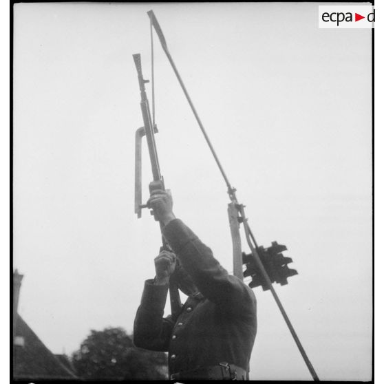 Plan moyen de face en contre-plongée de l'affût antiaérien pour FM M24/29 servi par un soldat de la 2e armée.