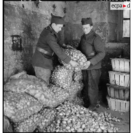 Des soldats pèsent des sacs de denrées dans un centre de l'intendance de la 2e armée.