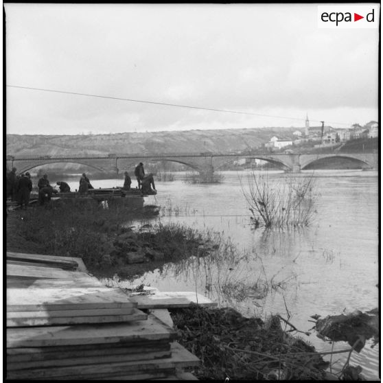 Des sapeurs du génie de la 3e armée construisent une passerelle de bois sur la Moselle.