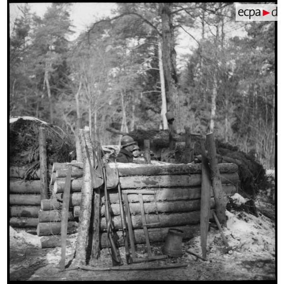 Photographie de groupe de soldats de la 5e armée en poste dans un abri de rondins.