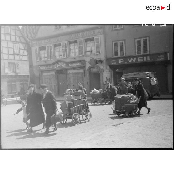 Un groupe de réfugiés traverse le village de Haguenau le secteur de la 5e armée.