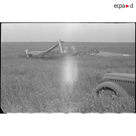 La carcasse d'un bombardier français Leo 45 avec sur la droite du cliché, la voiture Opel "Kapitän" du reporter.