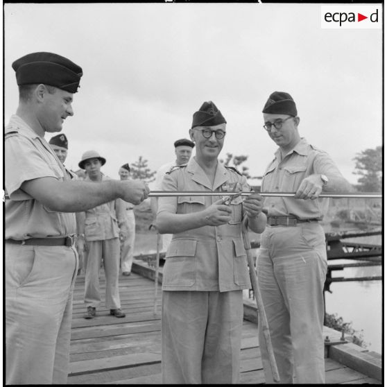 Le colonel Gambiez, commandant la zone delta-nord, coupe le ruban symbolique lors de l'inauguration du pont de Trinh Duc Ha.
