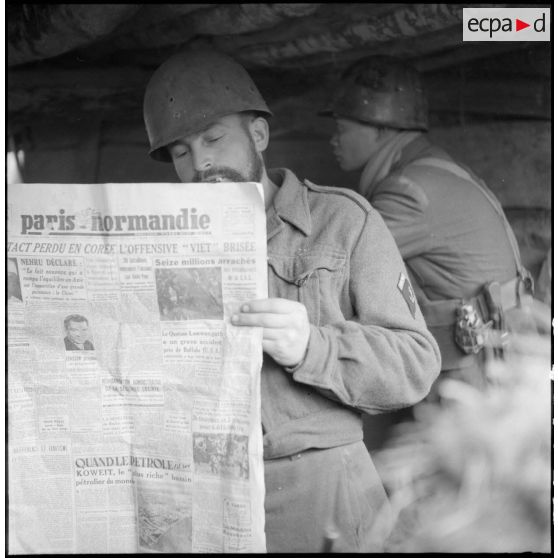 Lecture du journal par un sergent de la 9e compagnie du 3e bataillon du 21e régiment d'infanterie coloniale (3/21e RIC) dans une tranchée du point d'appui du col des Ananas.