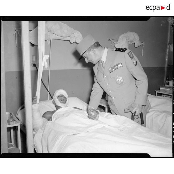 Le général de Lattre de Tassigny, commandant en chef en Indochine, et son épouse rendent visite à des blessés à l'hôpital Lanessan d'Hanoï.