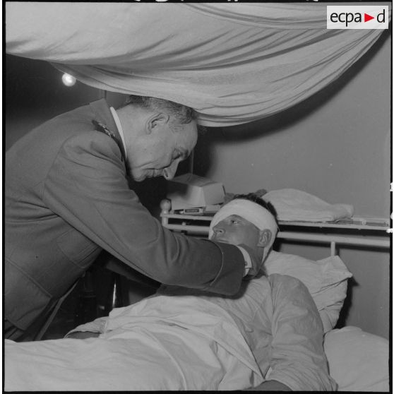 Remise de décorations à un blessé français par le général de Lattre de Tassigny.